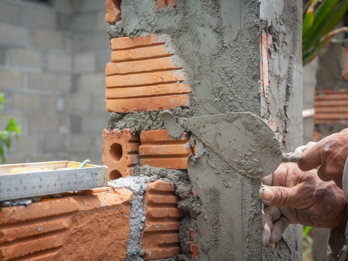 Bricklaying. Construction worker building a brick wall.