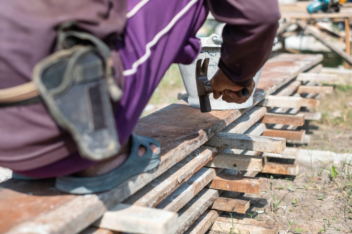 Carpenter holding a hammer and nails for construction work